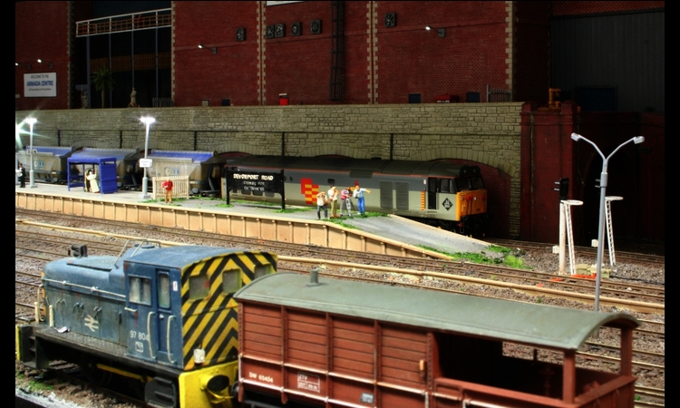 Departmental 06 shunts a brake van as 50149 with a china clay train waits the signal in the background.